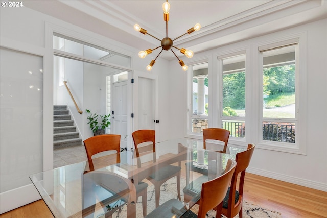 dining room with an inviting chandelier and light wood-type flooring