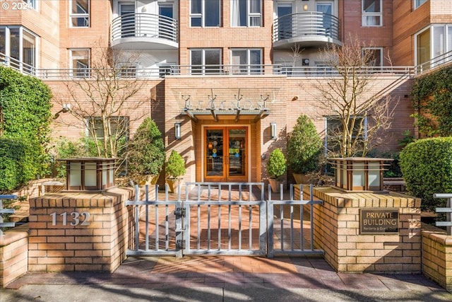 exterior space with a balcony and french doors