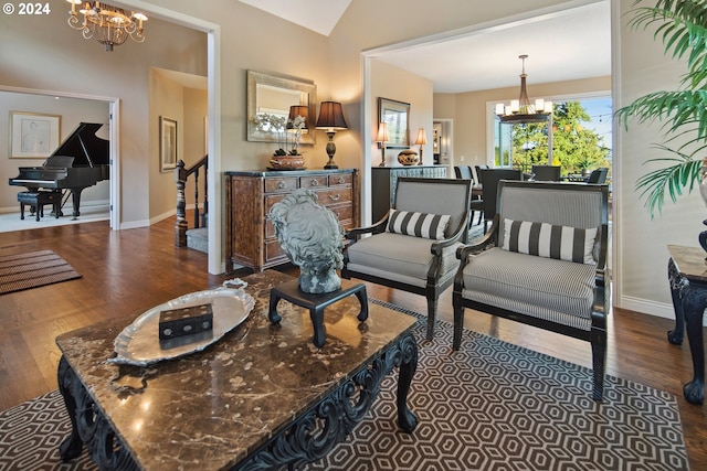 living room featuring dark hardwood / wood-style floors, a chandelier, and vaulted ceiling