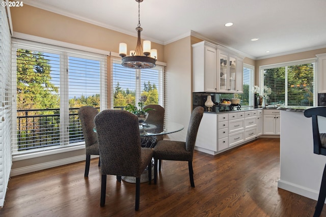 dining area featuring an inviting chandelier, dark wood-type flooring, ornamental molding, and plenty of natural light