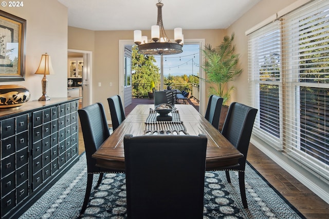 dining room featuring dark wood-type flooring, an inviting chandelier, and a mail area