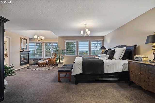 bedroom featuring a chandelier, multiple windows, and dark colored carpet