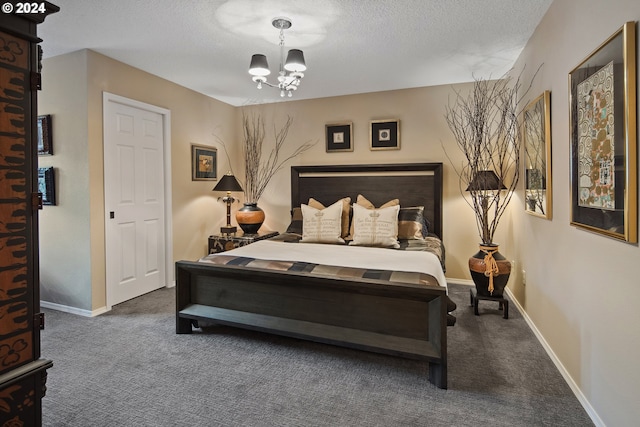 carpeted bedroom with an inviting chandelier and a textured ceiling