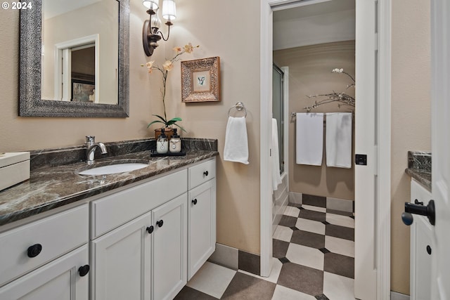 bathroom featuring walk in shower and vanity