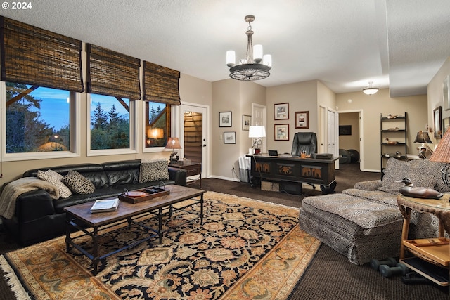 carpeted living room with a chandelier and a textured ceiling