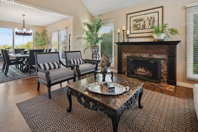 living room featuring vaulted ceiling, a healthy amount of sunlight, and hardwood / wood-style floors