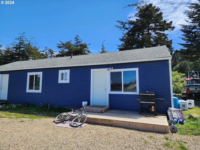 back of house with a wooden deck