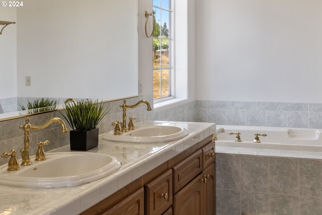 bathroom featuring vanity and a relaxing tiled tub