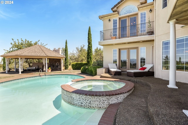 view of swimming pool featuring a gazebo, a patio area, french doors, and an in ground hot tub