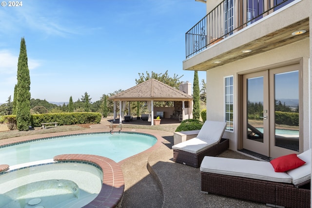 view of swimming pool with a gazebo, a patio, french doors, and an in ground hot tub