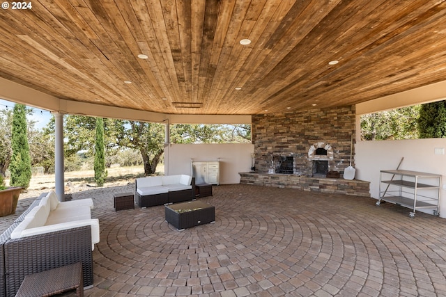 view of patio featuring an outdoor living space with a fireplace