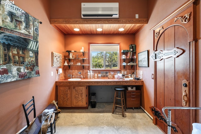 office space with sink, an AC wall unit, and wooden ceiling