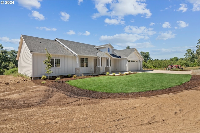 view of front of home with a front yard and a garage