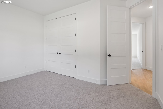 unfurnished bedroom with carpet flooring and a closet