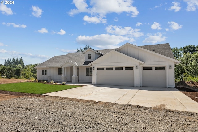 modern farmhouse style home featuring a front lawn and a garage