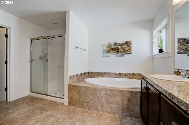 bathroom featuring shower with separate bathtub, tile floors, a textured ceiling, and vanity