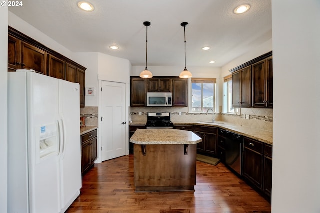 kitchen featuring decorative light fixtures, white fridge with ice dispenser, a kitchen island, dark hardwood / wood-style floors, and dishwasher