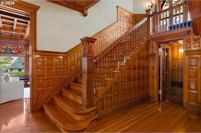 1816 SW Hawthorne Ter, Portland, OR 97201 - stairs featuring wood finished floors, beamed ceiling, a decorative wall, crown molding, and coffered ceiling