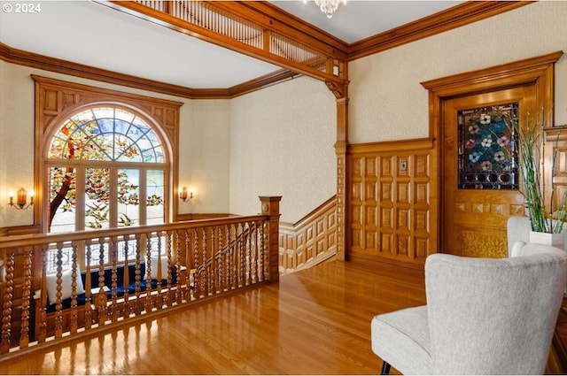 1816 SW Hawthorne Ter, Portland, OR 97201 - sitting room with an upstairs landing, crown molding, wood finished floors, a chandelier, and a wainscoted wall
