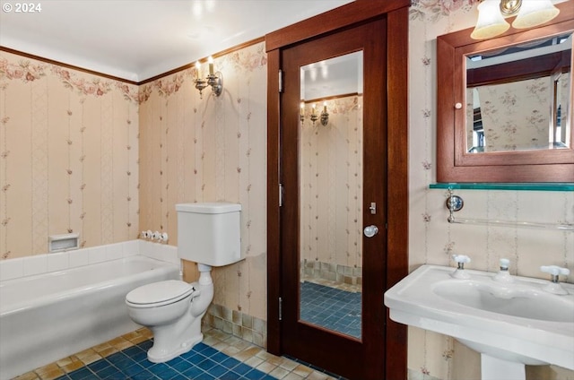 full bathroom featuring wallpapered walls, toilet, a sink, a bath, and tile patterned floors