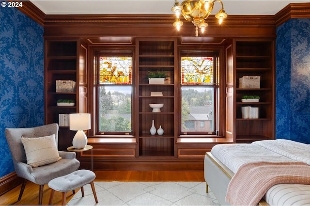 bedroom with light wood-style floors, an inviting chandelier, and wallpapered walls