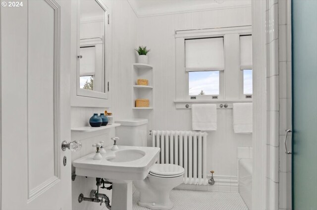 bathroom with radiator, plus walk in shower, tile patterned floors, crown molding, and toilet