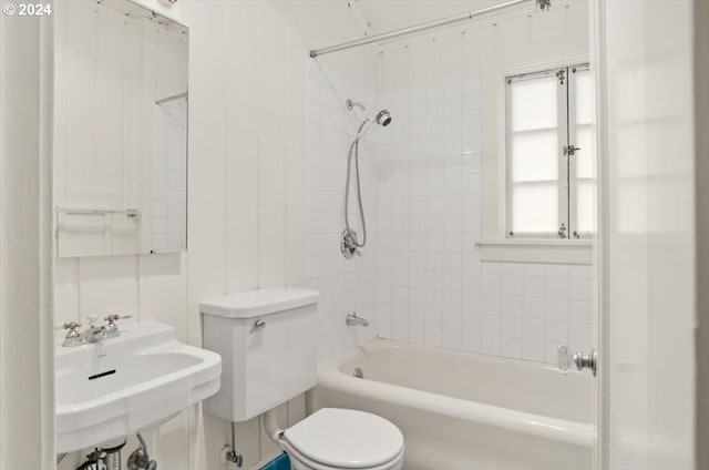 full bathroom with  shower combination, a sink, and toilet