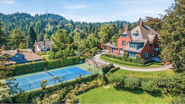 birds eye view of property with a forest view