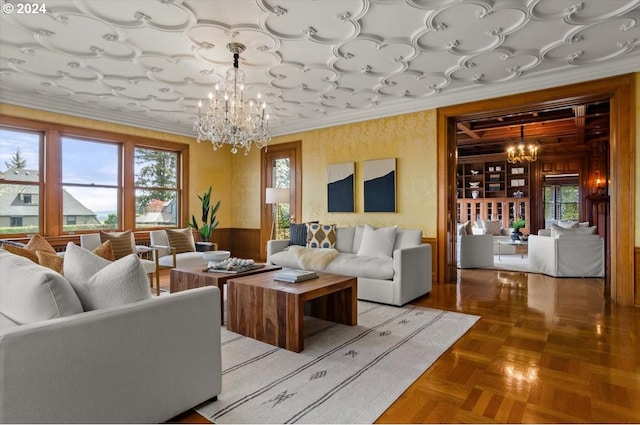 living room featuring crown molding, parquet flooring, a notable chandelier, and wooden walls