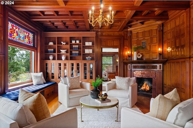 sitting room with coffered ceiling, wooden ceiling, wood finished floors, wood walls, and a fireplace