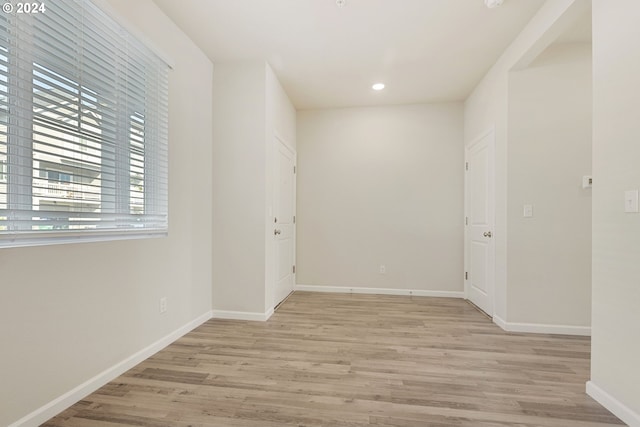 empty room with light hardwood / wood-style flooring