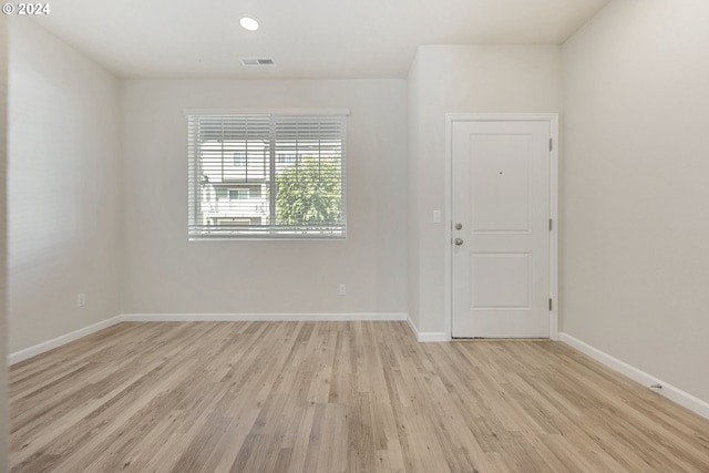 empty room with light hardwood / wood-style floors