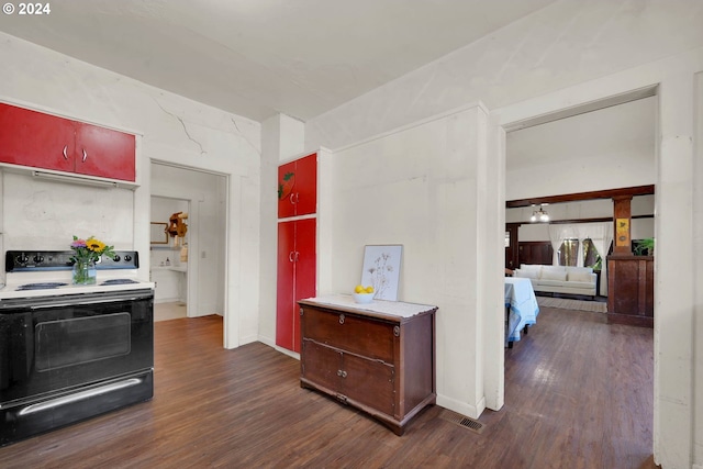 kitchen with dark hardwood / wood-style floors and black electric range