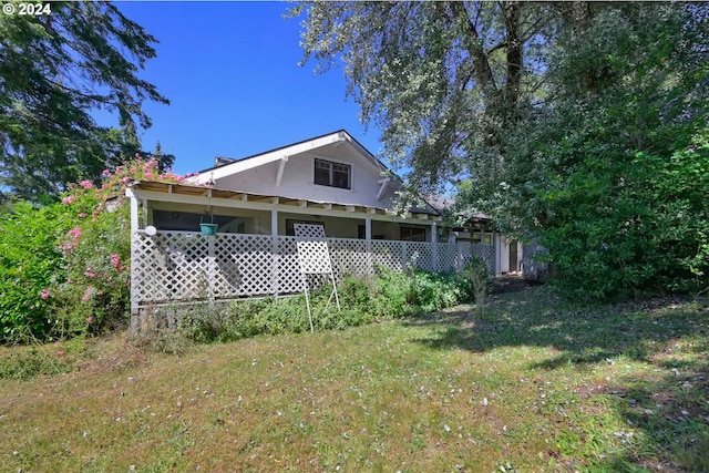 rear view of house with a yard