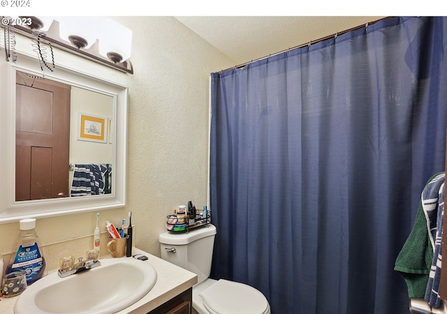 9630 SE Foster Rd, Portland, OR 97266 - bathroom featuring a textured wall, toilet, and vanity