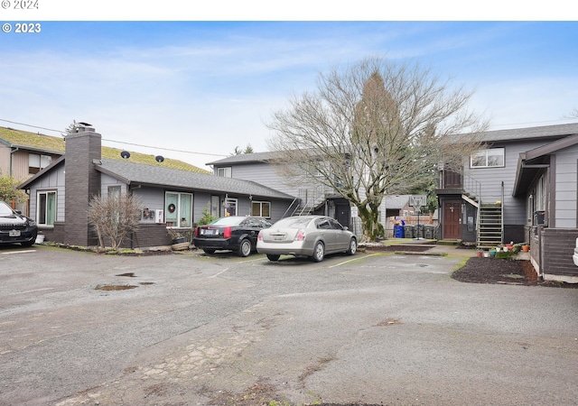 9630 SE Foster Rd, Portland, OR 97266 - view of front of house featuring uncovered parking, a chimney, stairs, and a residential view
