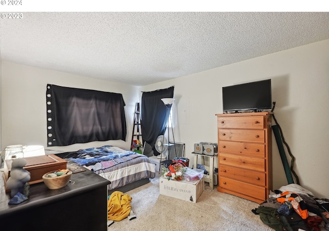 bedroom featuring carpet flooring and a textured ceiling