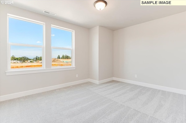 unfurnished room with plenty of natural light and light colored carpet