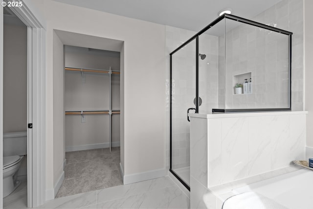 12785 SW Trask St, Beaverton, OR 97007 - bathroom with a shower stall, toilet, a walk in closet, baseboards, and marble look tiles