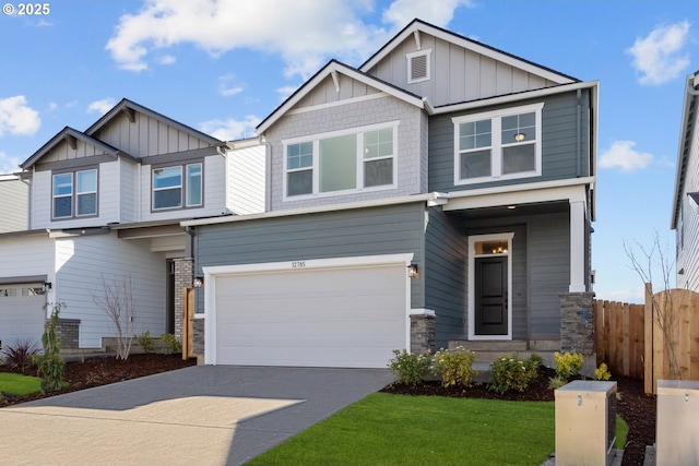 12785 SW Trask St, Beaverton, OR 97007 - craftsman-style house with board and batten siding, an attached garage, fence, driveway, and stone siding