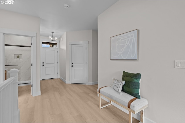 12785 SW Trask St, Beaverton, OR 97007 - foyer with light wood-style flooring, a chandelier, and baseboards