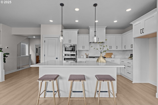 12785 SW Trask St, Beaverton, OR 97007 - kitchen with appliances with stainless steel finishes, light wood-style flooring, a sink, light countertops, and recessed lighting