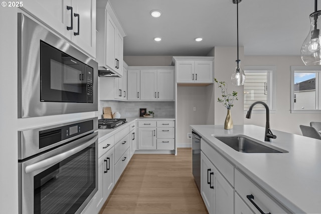 12785 SW Trask St, Beaverton, OR 97007 - kitchen with stainless steel appliances, a sink, light countertops, recessed lighting, and white cabinets