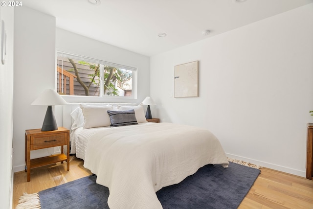 bedroom with hardwood / wood-style floors