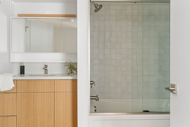 bathroom featuring vanity and combined bath / shower with glass door