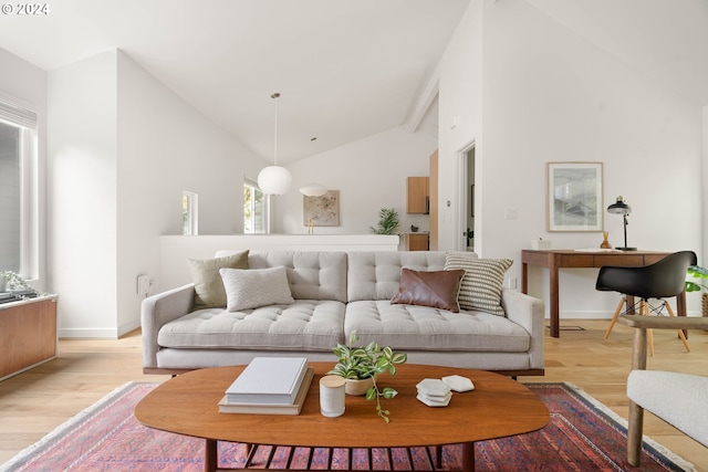 living room featuring light hardwood / wood-style flooring and high vaulted ceiling