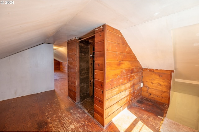 bonus room featuring lofted ceiling and dark hardwood / wood-style flooring