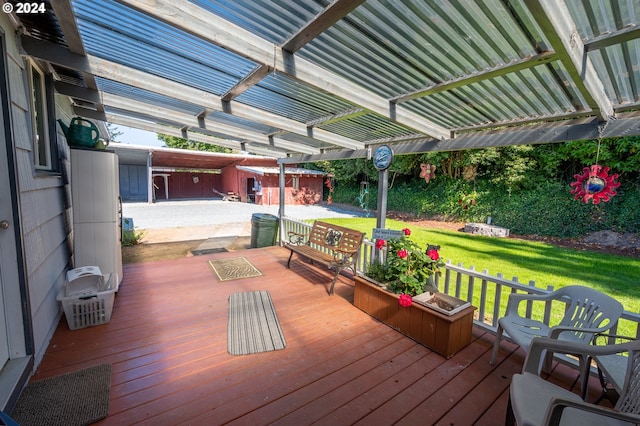 wooden deck featuring a storage unit, a pergola, and a yard