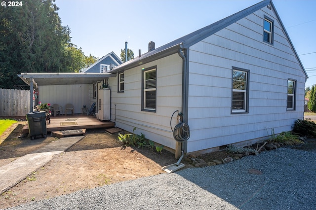 view of front of house featuring water heater and a wooden deck