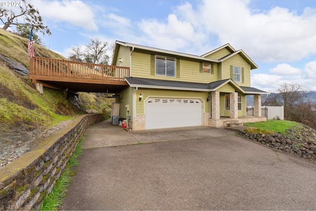 view of front of home featuring a garage and a deck